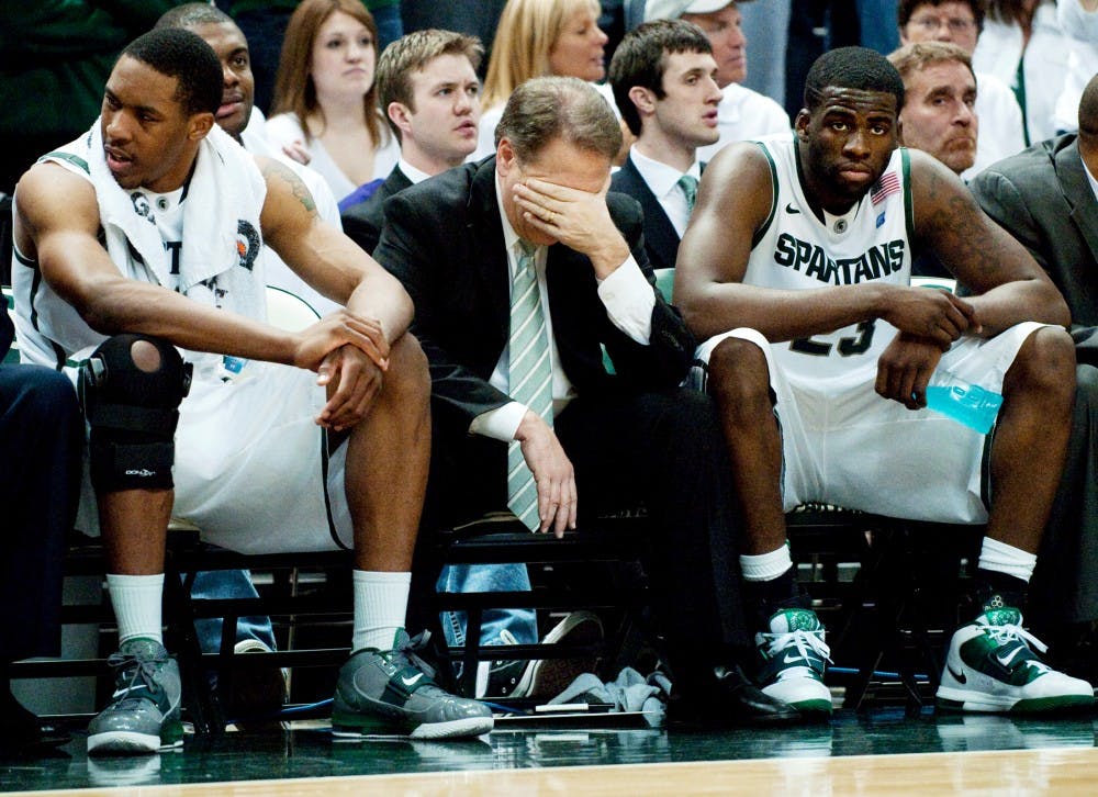 Head coach Tom Izzo buries his head into his hand as a dejected junior forward Draymond Green looks on. The Spartans fall to 16-12 for the season after they were defeated, 67-47, on Sunday afternoon at Breslin Center. Josh Radtke/The State News