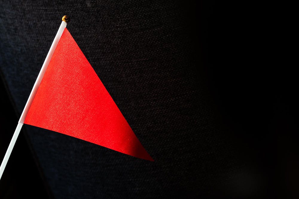 A spectator holds a red flag during the “Hard Reset: It’s Not You, It’s Them” event at the Graduate Hotel in East Lansing, Mich., on April 7, 2026.