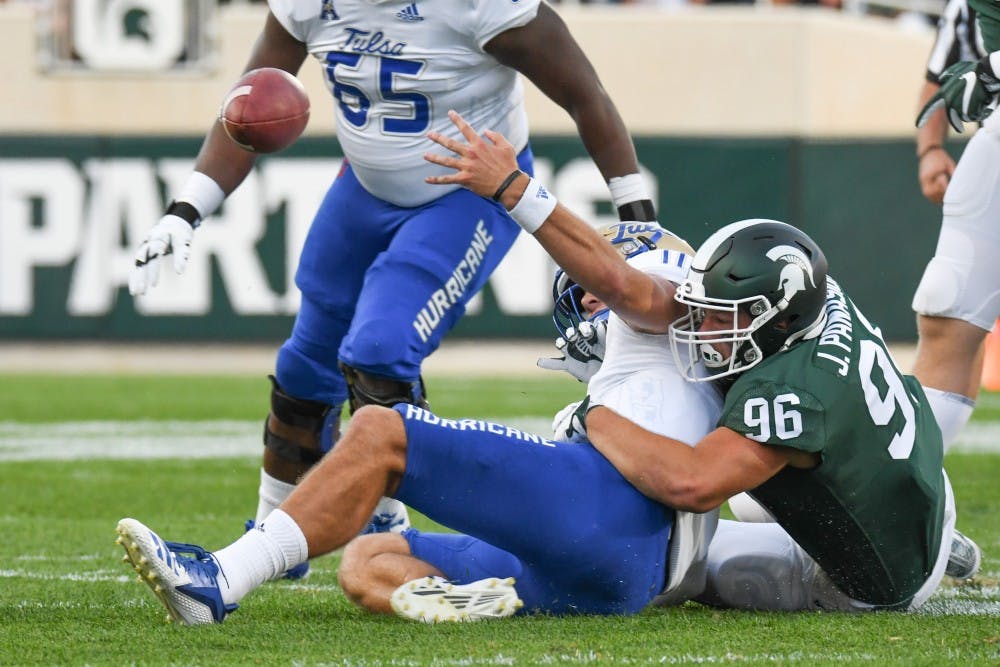 <p>Junior defensive end Jacub Panasiuk (96) forces a fumble during the game against Tulsa at Spartan Stadium on Aug. 30, 2019. The Spartans defeated the Golden Hurricane, 28-7.</p>