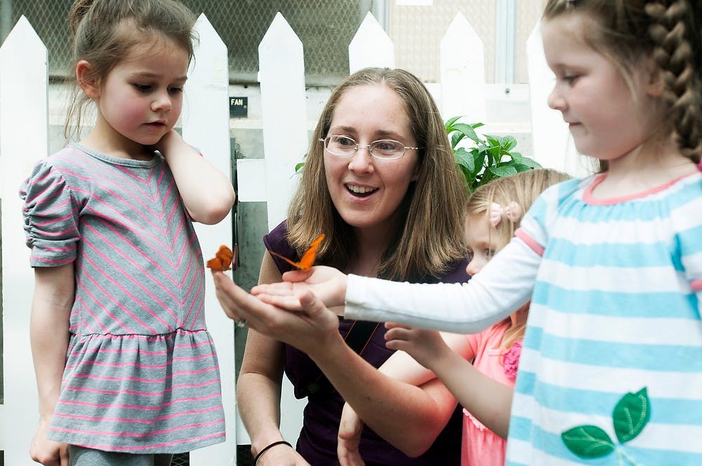 <p>From left, Okemos, Mich., residents Olivia Giltner, 5, Jamie Meoak, Ava Meoak, 2, and Hannah Meoak, 4, look at butterflies April 21, 2014, at the Indoor Children's Garden and Butterfly House near Plant and Soil Sciences. Meoak, along with friends and family, was there for the first time. Danyelle Morrow/The State News</p>