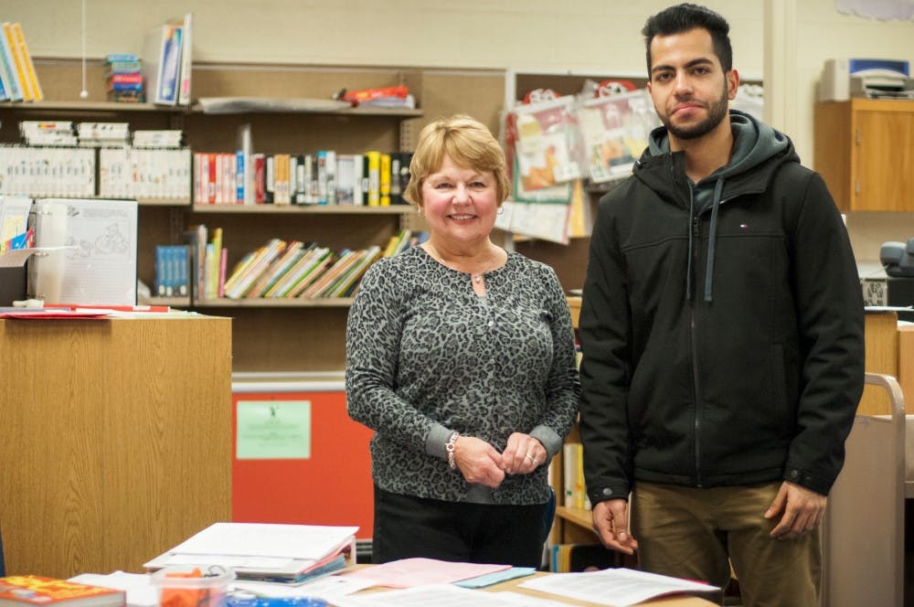 DeWitt resident Sharon Mathews poses for a picture with human biology junior Ardwan Meshaal on Jan. 25, 2017 at Cumberland Elementary at 2801 Cumberland Road in Lansing. Students from Read to Succeed visited Cumberland Elementary to receive training. They will each be paired with one student to tutor twice a week. Mathews is the program coordinator and Meshaal is the site supervisor.