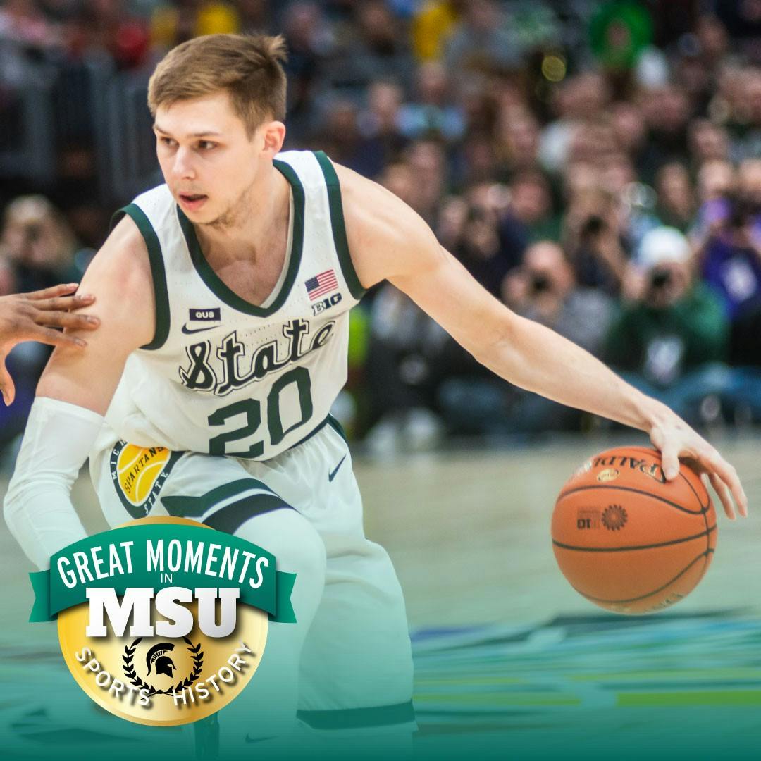 Senior guard Matt McQuaid (20) dribbles the ball against Michigan. The Spartans beat the Wolverines, 65-60, at the United Center on March 17, 2019. Photo by Matt Zubik. Design by Daena Faustino.