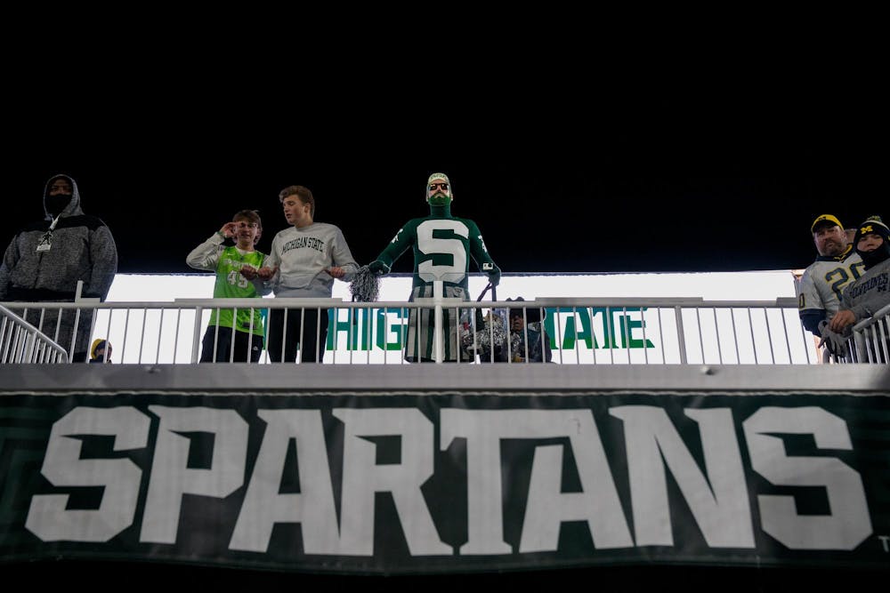 MSU Fan known as Johnny Spirit touches the Spartan statue ahead of the Michigan State University verses University of Michigan at Spartan Stadium in East Lansing, Michigan on Saturday, Oct. 25, 2025. 