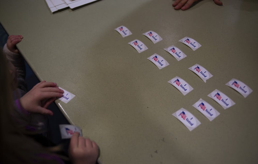 <p>People grab “I voted” stickers in the East Lansing City Council Election on Nov. 5, 2019 at Hannah Community Center.</p>