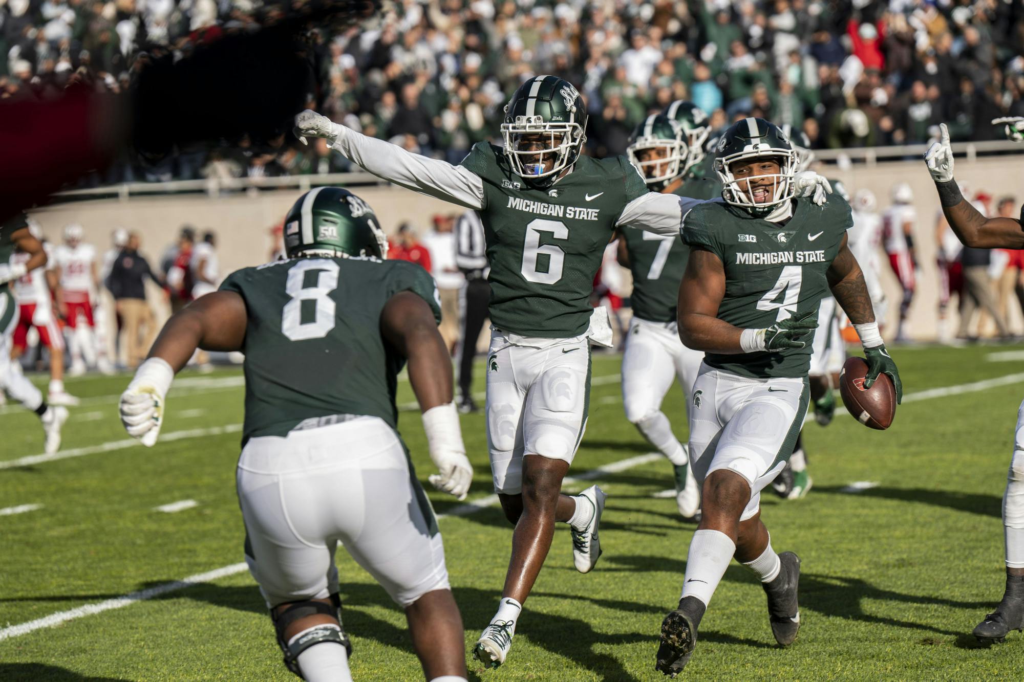 Conerback Ameer Speed (6) and defendive end Jacoby Windmon (4) celebrate after a touchdown during the game against Wisconsin on October 15, 2022. 