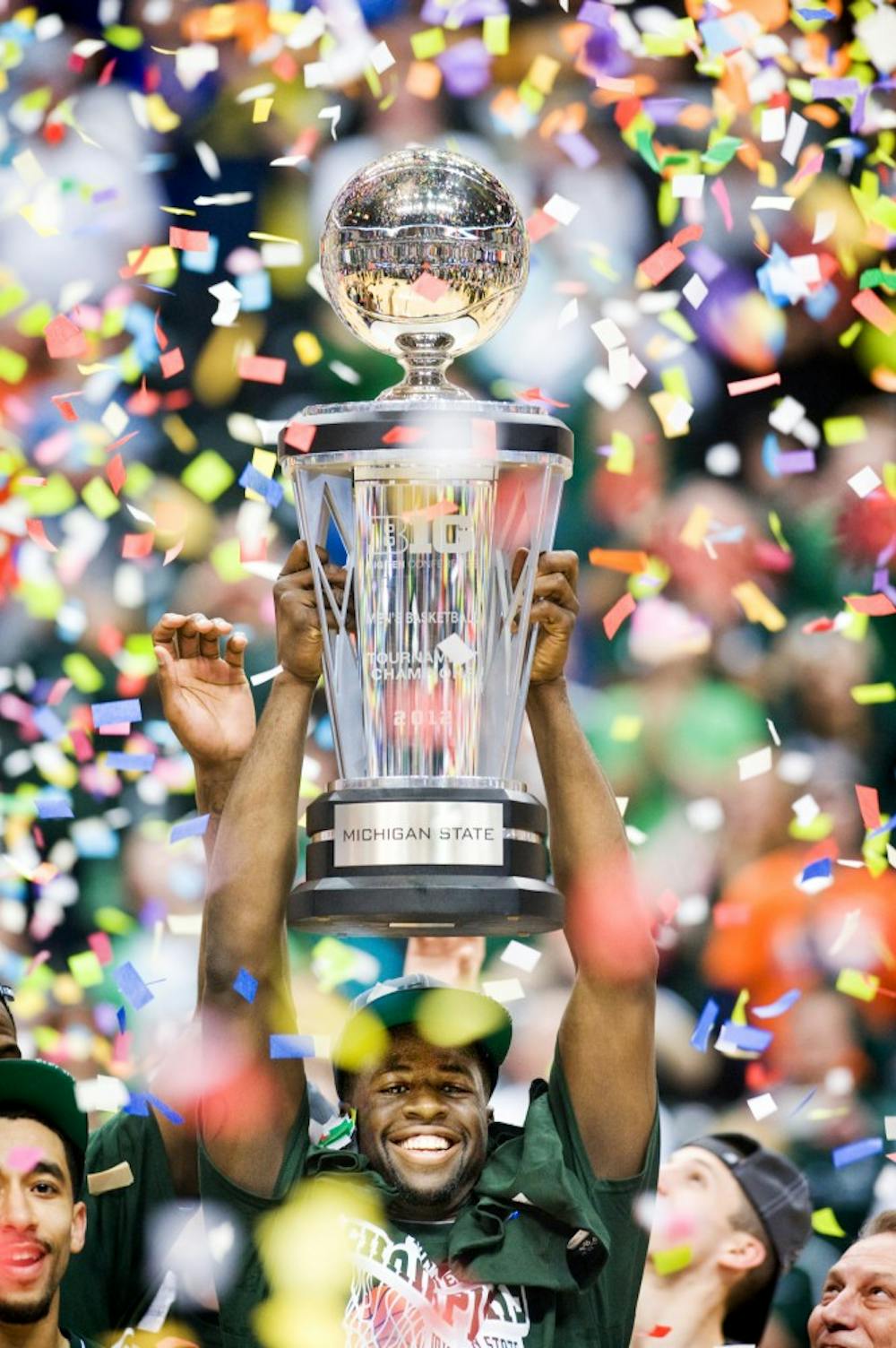 Senior forward Draymond Green hands the Big Ten Tournament championship trophy up after the game against Ohio State. The Michigan State Spartans win their first Big Ten Tournament in 12 years by defeating the Ohio State Buckeyes, 68-64, Sunday afternoon at Bankers Life Fieldhouse in Indianapolis. Justin Wan/The State News