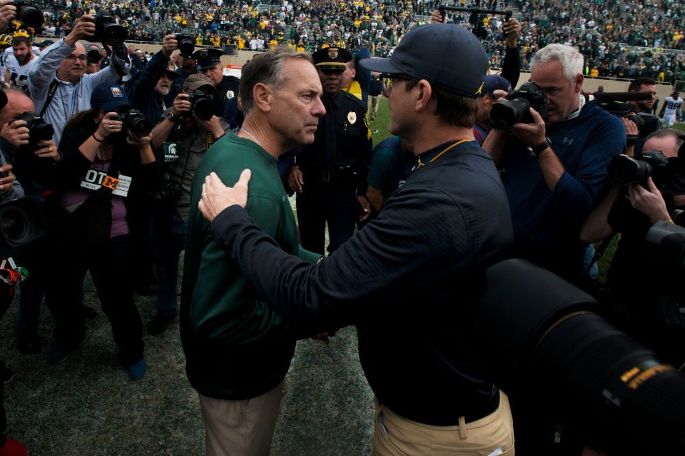 Head coach Mark Dantonio and Jim Harbaugh shake hands after the game against Michigan on Oct. 29, 2016 at Spartan Stadium. The Spartans were defeated by the Wolverines, 32-23.
