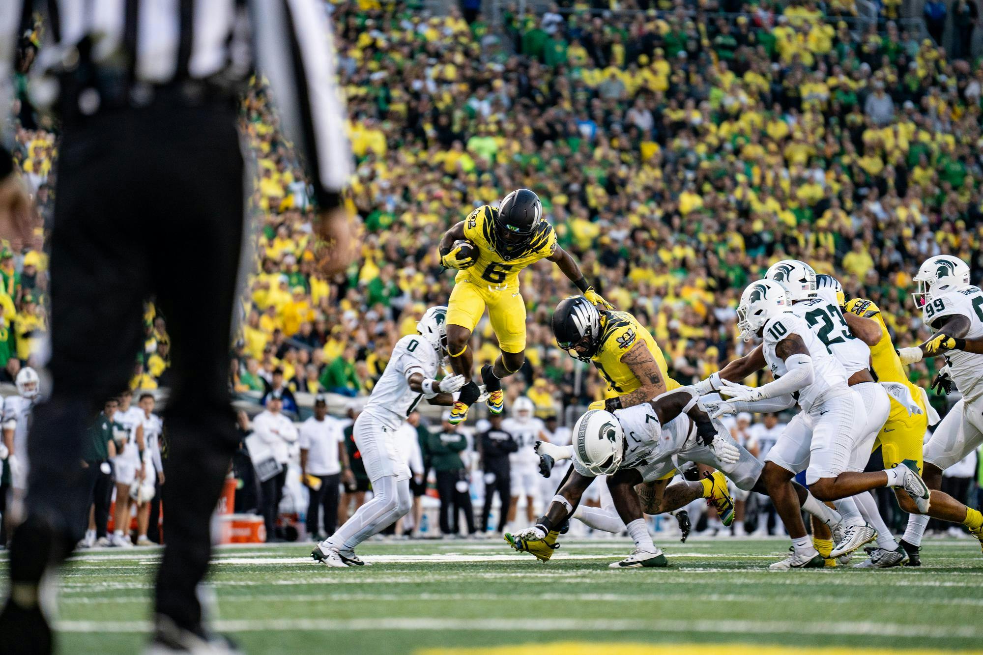 <p>University of Oregon redshirt junior running back Noah Whittington leaps into the air with the ball on Oct. 4, 2024, in Autzen Stadium.</p>