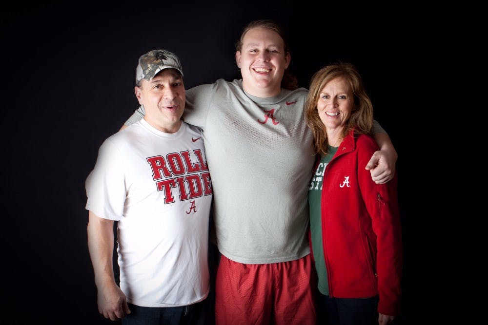 <p>Alabama offensive lineman Chris Posa, center, with his father Ron and his mother Diane. Both of his parents graduated from Michigan State.</p>