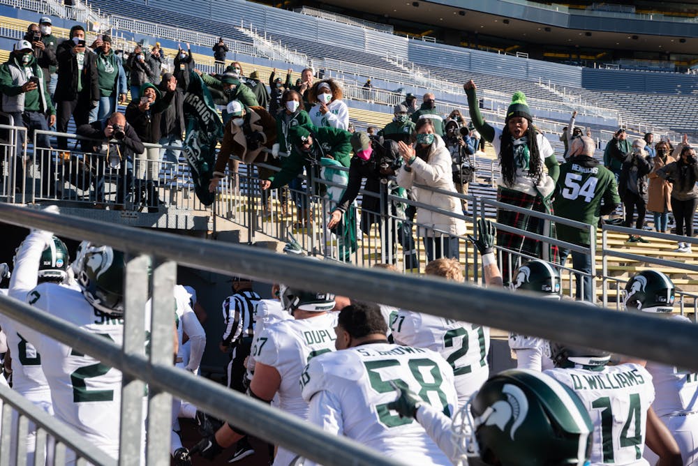 Spartan fans crowd around the tunnel to congratulation the MSU football team after winning 27-24 against the University of Michigsn in the big house on Oct. 31, 2020.