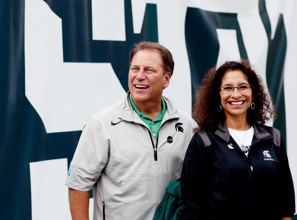 Basketball head coach Tom Izzo and his wife Lupe smile to football fans before the Spartans take the field against Florida Atlantic Saturday, Sept. 10 at Spartan Stadium. The Izzo family donated $1 mil. to Spartan Athletics, a large chunk of the money will be devoted to the football program. Matt Hallowell/The State News