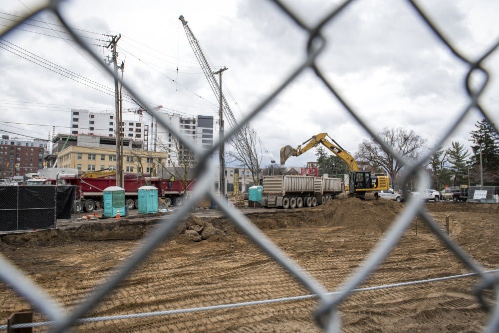 Constructions workers work at the Park District project in East Lansing on April 12, 2019. (Nic Antaya/The State News)