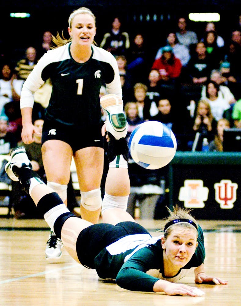 Redshirt senior outsider hitter and middle blocker Jenilee Rathje  falls to the floor after attempting to dig the volleyball. The Spartans fell against the Boilermakers, 3-1, Saturday night at Jenison Field House. Justin Wan/The State News