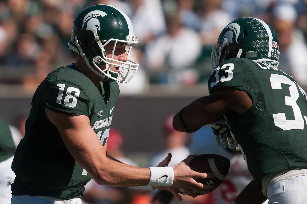 	<p>Sophomore quarterback Connor Cook hands off the ball to junior running back Jeremy Langford during the game against Indiana on Oct. 12, 2013. The Spartans defeated the Hoosiers, 42-28. Julia Nagy/The State News </p>