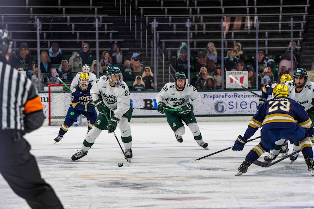<p>Jagger Joshua (23) works with Josh Nodler (20) to get the puck down to Notre Dame&#x27;s goal in the second period. The Fighting Irish shut out the Spartans, 2-0, on Feb. 27, 2021.</p>