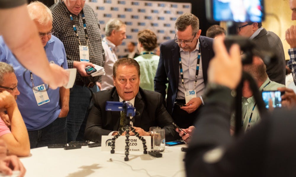 Head basketball coach Tom Izzo (center) surrounded by reporters during Big Ten basketball media day in Chicago on October 2, 2019. 
