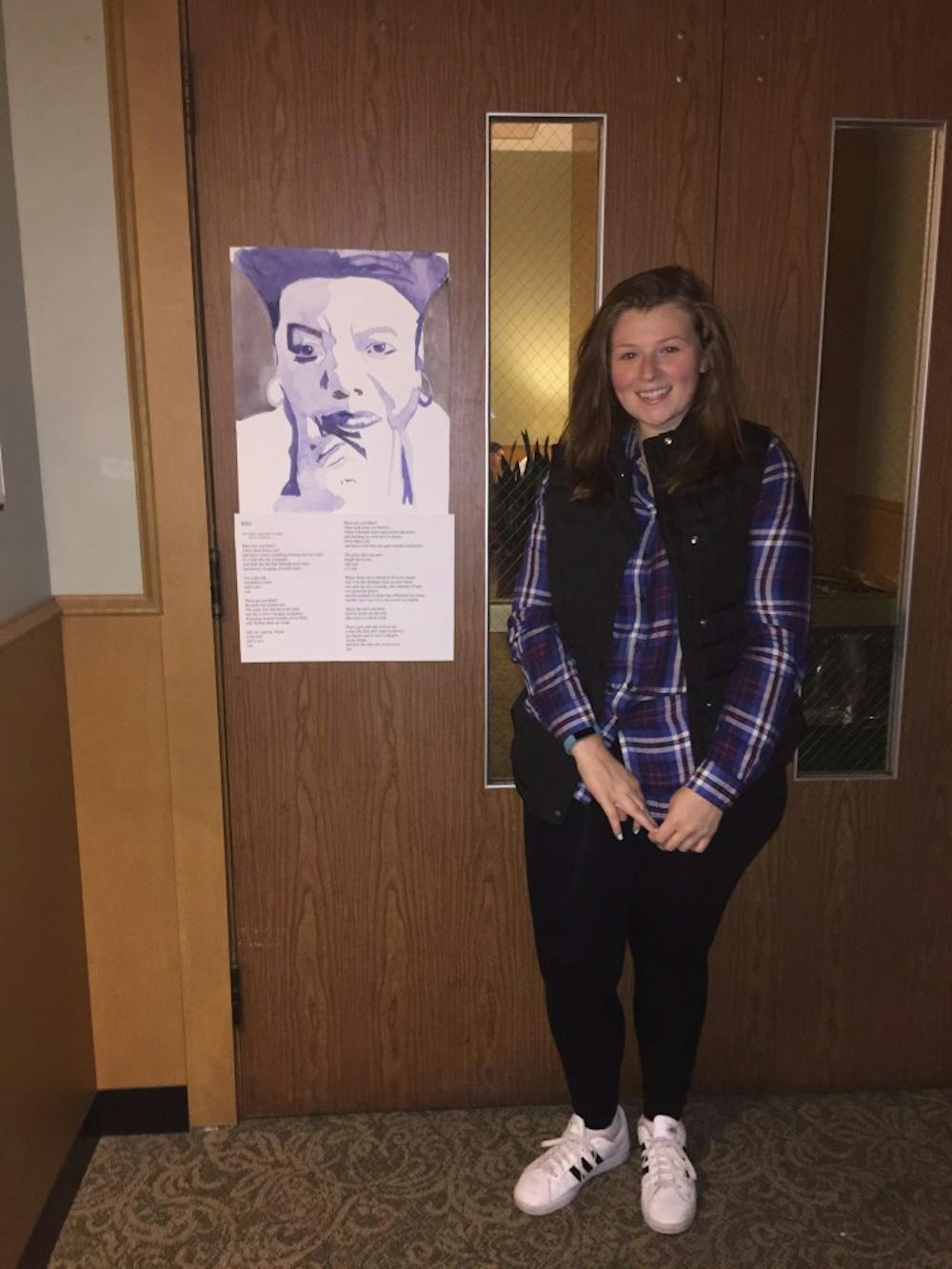 <p>English sophomore&nbsp;Anntaninna Biondo with her Maya Angelou inspired poem and painting.</p>