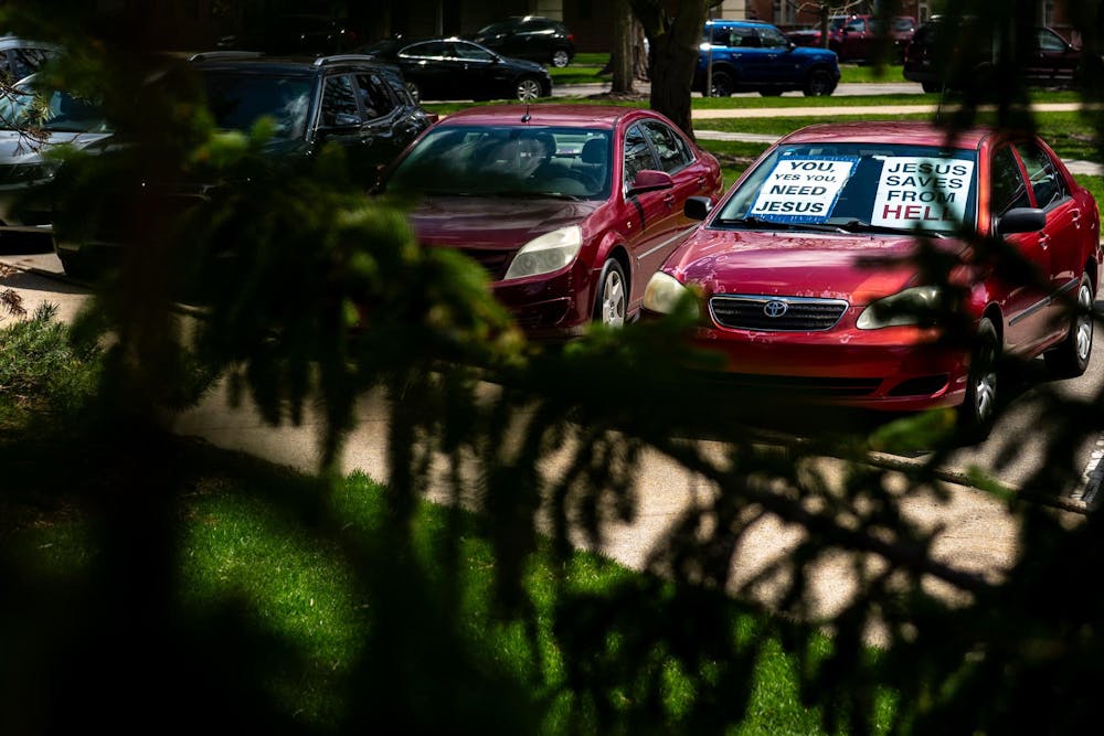 <p>A red car belonging to Pastor Michael Venyah, adorned with religious messaging, is parked outside the Hannah Administration Building on Michigan State University’s campus in East Lansing, Mich., on Monday, April 13, 2026.</p>