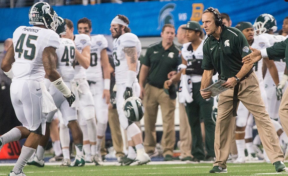 <p>Head coach Mark Dantonio greets his team as they come in for a time out Jan. 1, 2015, during The Cotton Bowl Classic football game against Baylor at AT&T Stadium in Arlington, Texas. The Spartans defeated the Bears and claimed the Cotton Bowl Victory, 42-41. Erin Hampton/The State News</p>