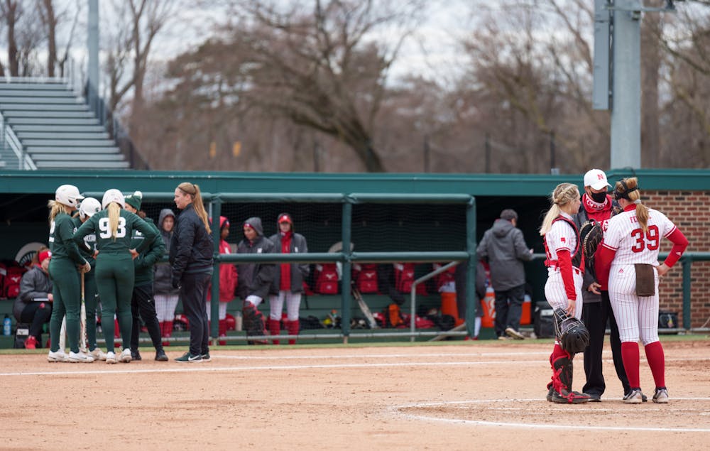 <p>Michigan State and Nebraska players talk with their coaches before the start of the next inning. Spartans lost 6-0 against Nebraska, on April 9, 2022.</p>