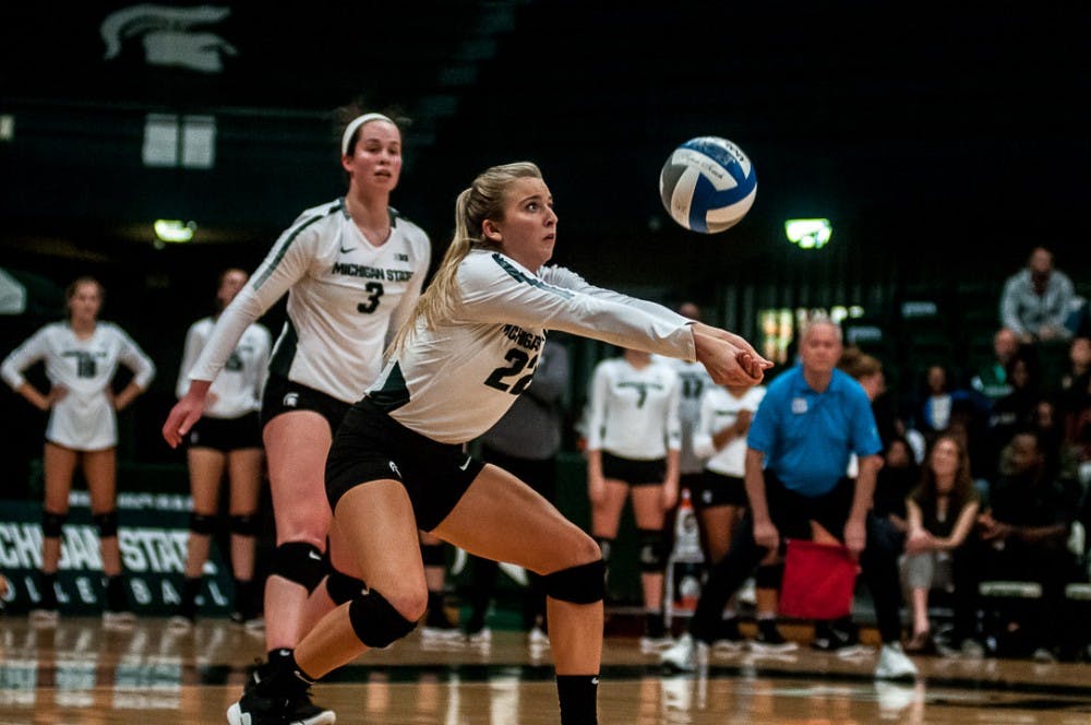 <p>Defensive specialist and libero Samantha Mclean (22) sets the ball during the game against Rutgers on Sept. 29, 2018 at Jenison Fieldhouse. The Spartans beat the Scarlet Knights, 3-1.&nbsp;</p>