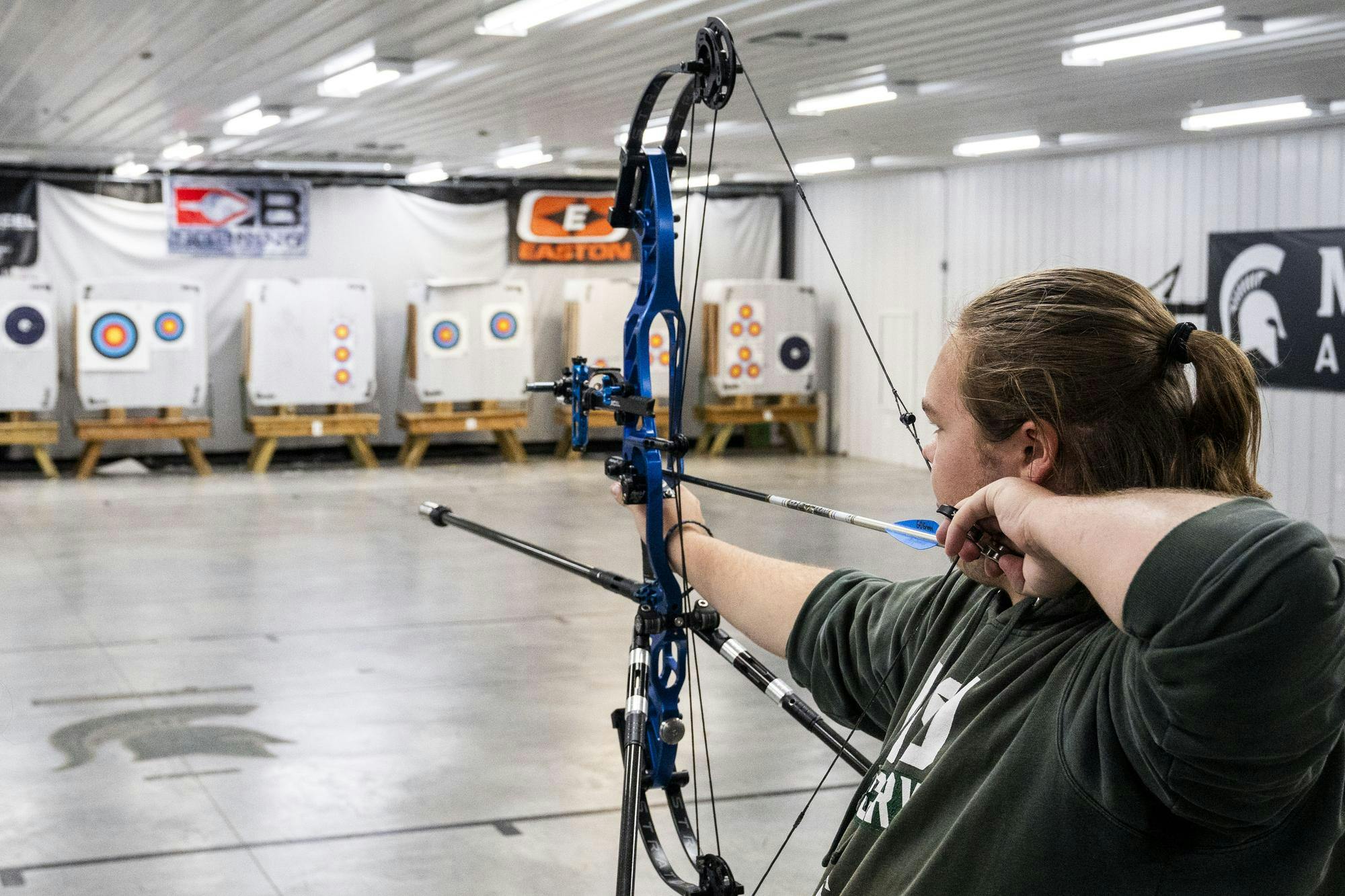  The MSU archery team president, biochemistry junior Leland Huber, aims for the target at the Demmer Center in East Lansing, Michigan, on Oct. 26, 2025. He has been a member of the team since his freshman year. 