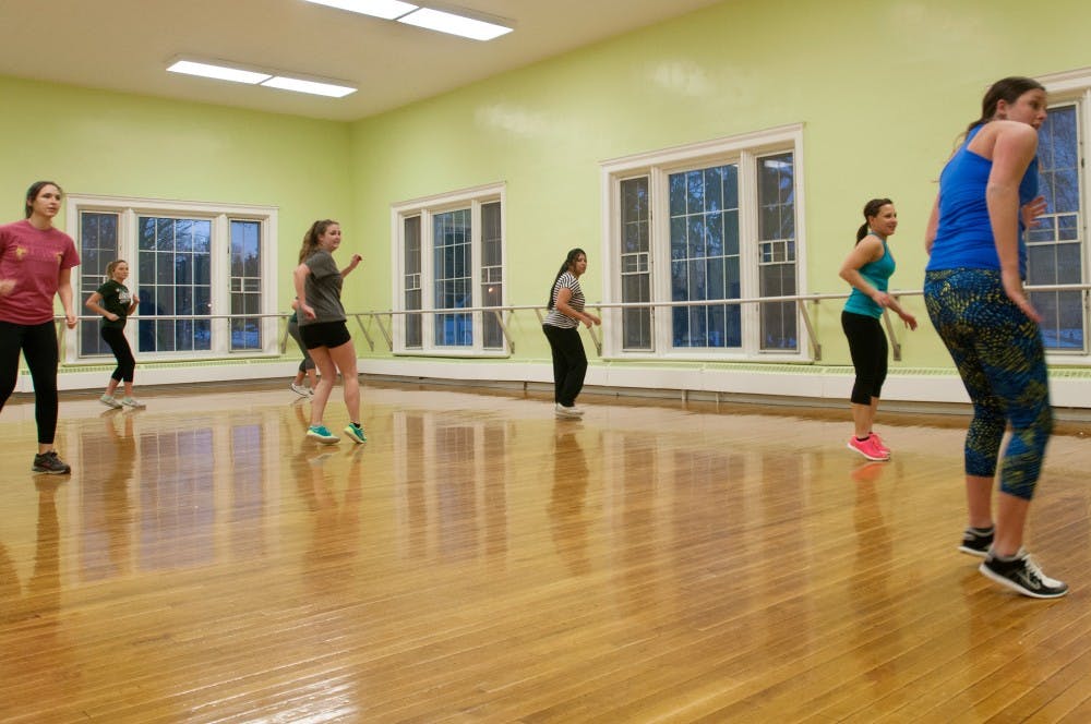 <p>Graduate student Sarah McCormick leads a Zumba class Jan. 13, 2015, in room 218 in IM Sports Circle. She leads a class in McDonel Hall on Sundays also. Allyson Telgenhof/The State News.</p>