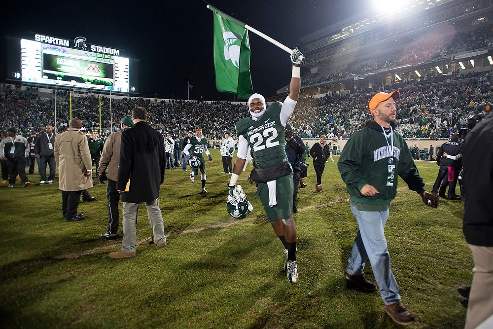 	<p>Freshman running back Delton Williams runs with a Spartan flag after the game against the University of Michigan on Nov. 2, 2013, at Spartan Stadium. The Spartans defeated the Wolverines, 29-6. Julia Nagy/The State News </p>