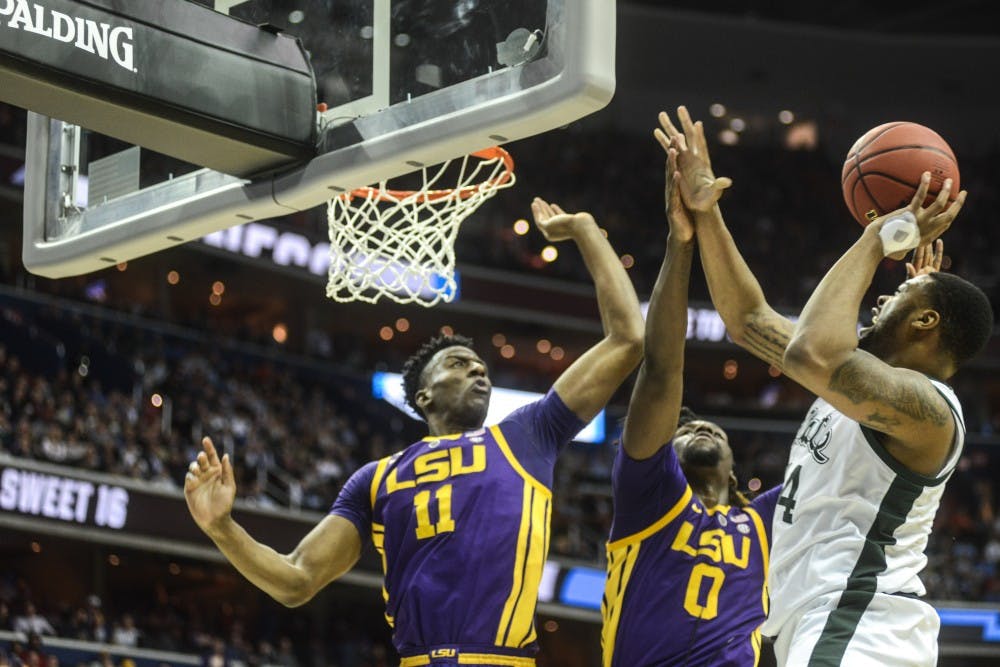 Junior forward Nick Ward (44) jumps with the ball against LSU’s forward Naz Reid (0) and forward Kavell Bigby-Williams (11) during the game against LSU at Capital One Arena on March 29, 2019. Ward hurt himself in the act. The Spartans defeated the Tigers, 80-63.