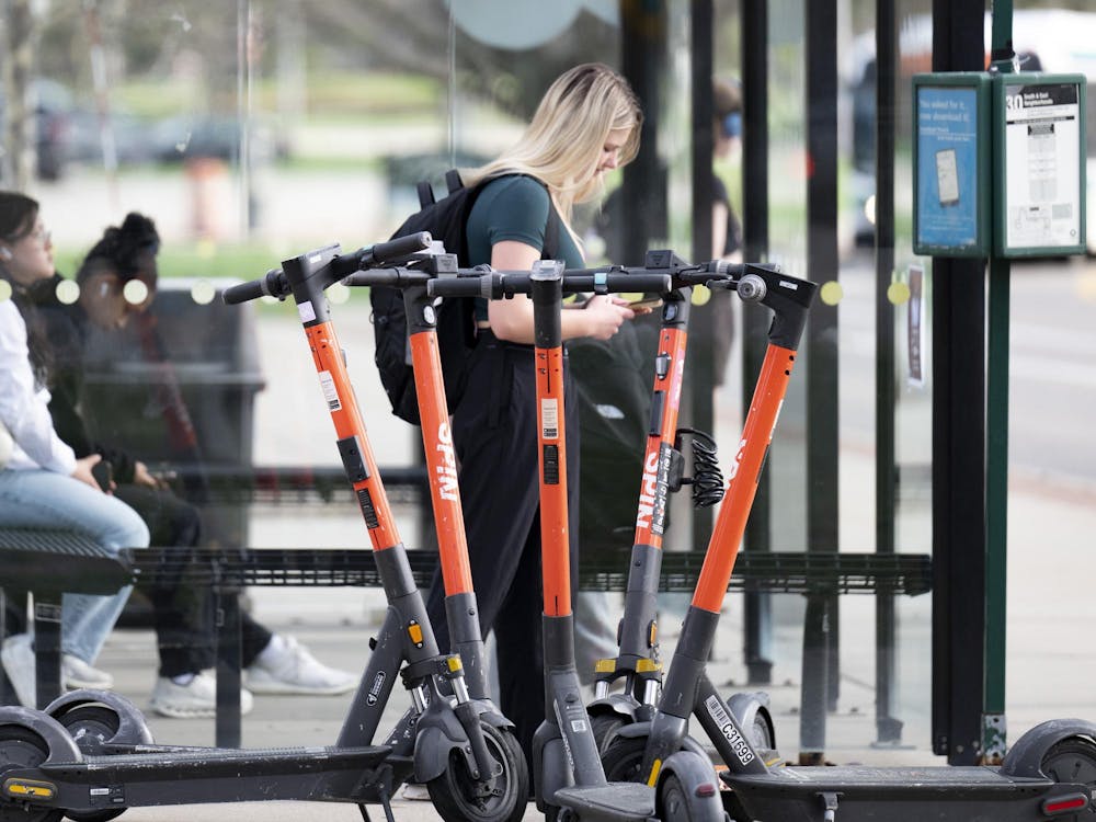Scooters parked by the bus stop near Akers Hall at Michigan State University campus on April 14, 2025
