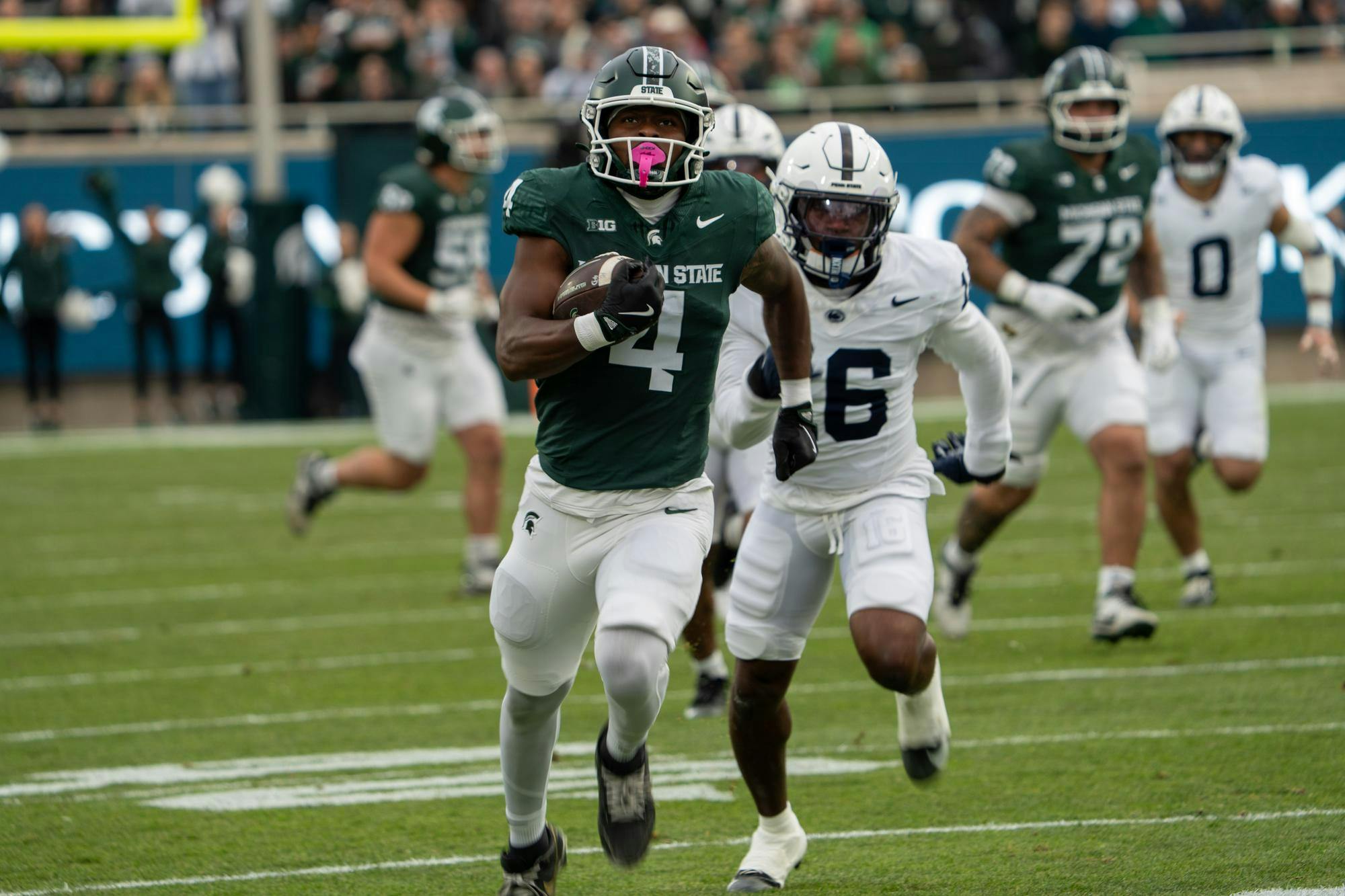 <p>Elijah Tau-Tolliver (4), a senior running back for Michigan State, powers into the end zone for a touchdown in East Lansing, Mich. on Saturday, Nov. 15, 2025. He broke through the line and outran the defenders to give the Spartans a key score.</p>