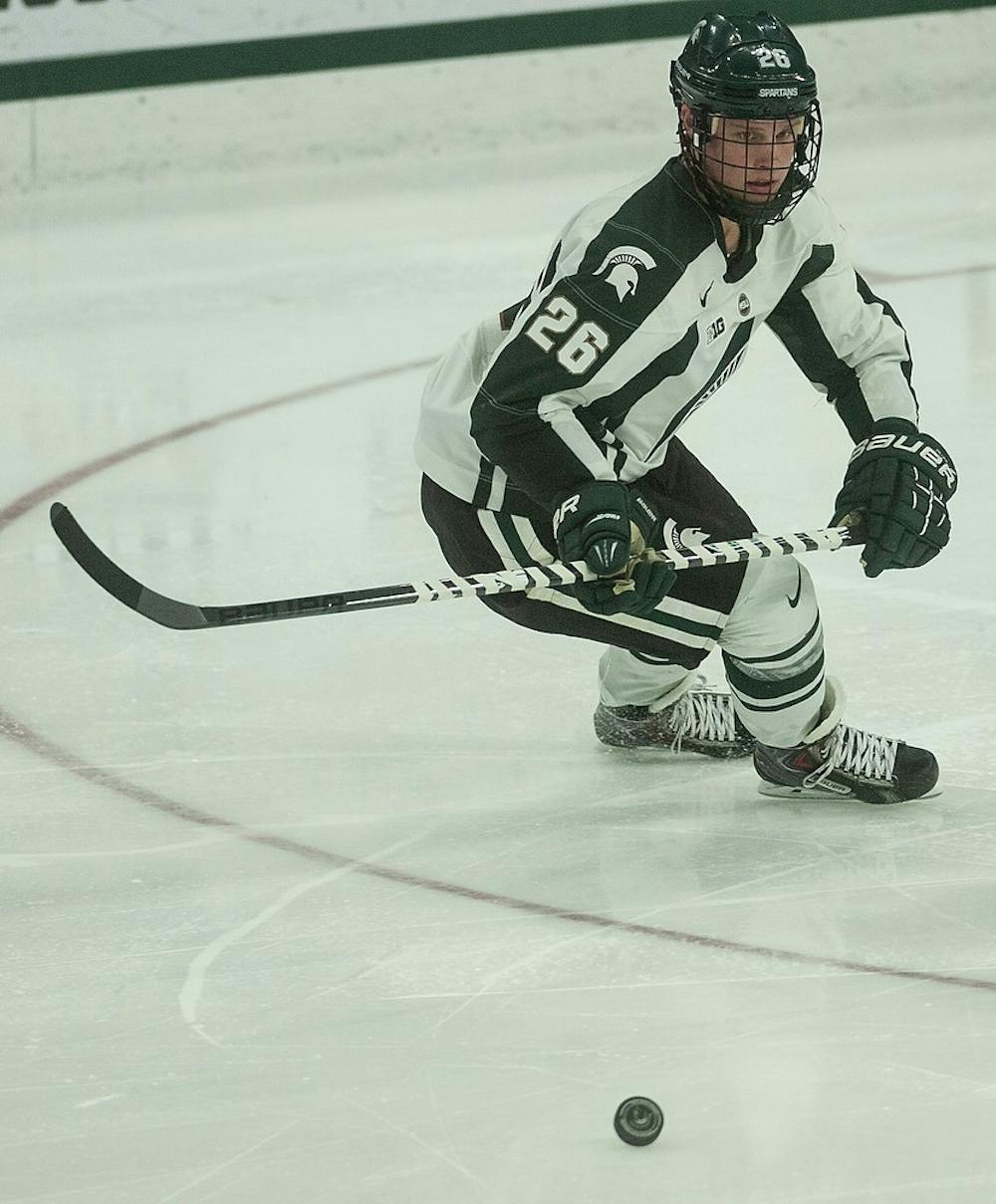 <p>Sophomore forward Villiam Haag takes the puck down the ice Jan. 23, 2015, during a game against Ohio State  at Munn Ice Arena. The Spartans defeated the Buckeyes, 4-1. Alice Kole/The State News</p>