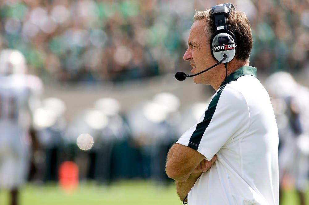 <p>Football head coach Mark Dantonio watches the players on the field between plays during the game against Florida Atlantic University on Sept. 10, 2011, at Spartan Stadium. Lauren Wood/The State News</p>