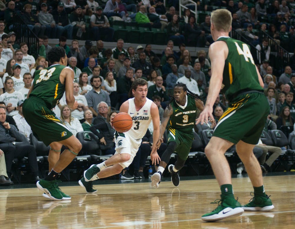 Freshman guard Foster Loyer (3) dribbles the ball down the court during the game against Northern Michigan at Breslin Center on Oct. 30, 2018. The Spartans defeated the Wildcats, 93-47.