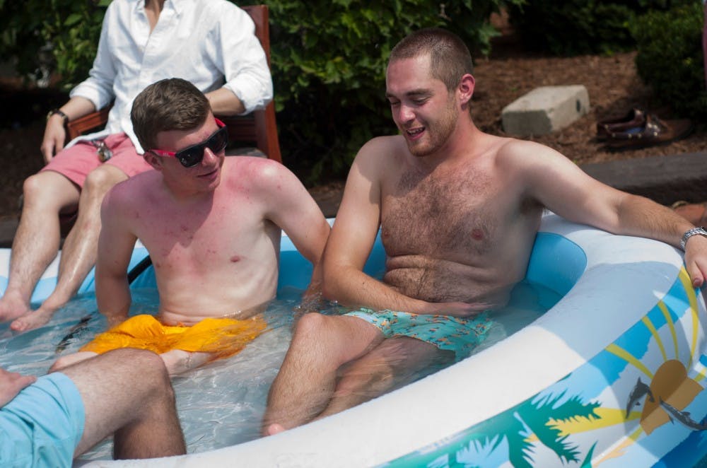 <p>Marketing sophomore Drake Pompei, left,  and chemical engineering sophomore Anthony Fiorini hang out in an inflatable pool on Sept. 7, 2015, outside Phi Kappa Psi, 522 Abbot Road, in East Lansing. "[We're just] trying to enjoy the last few days of summer before school gets going," Fiorini said. Treasure Roberts/The State News</p>