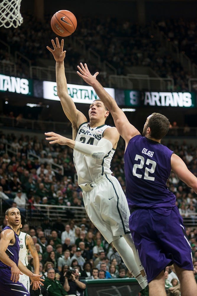 <p>Sophomore forward Gavin Schilling attempts a point over Northwestern center Alex Olah Jan. 11, 2015, during the game against Northwestern at Breslin Center.  The Spartans defeated the Wildcats, 84-77 in overtime. Erin Hampton/The State News</p>