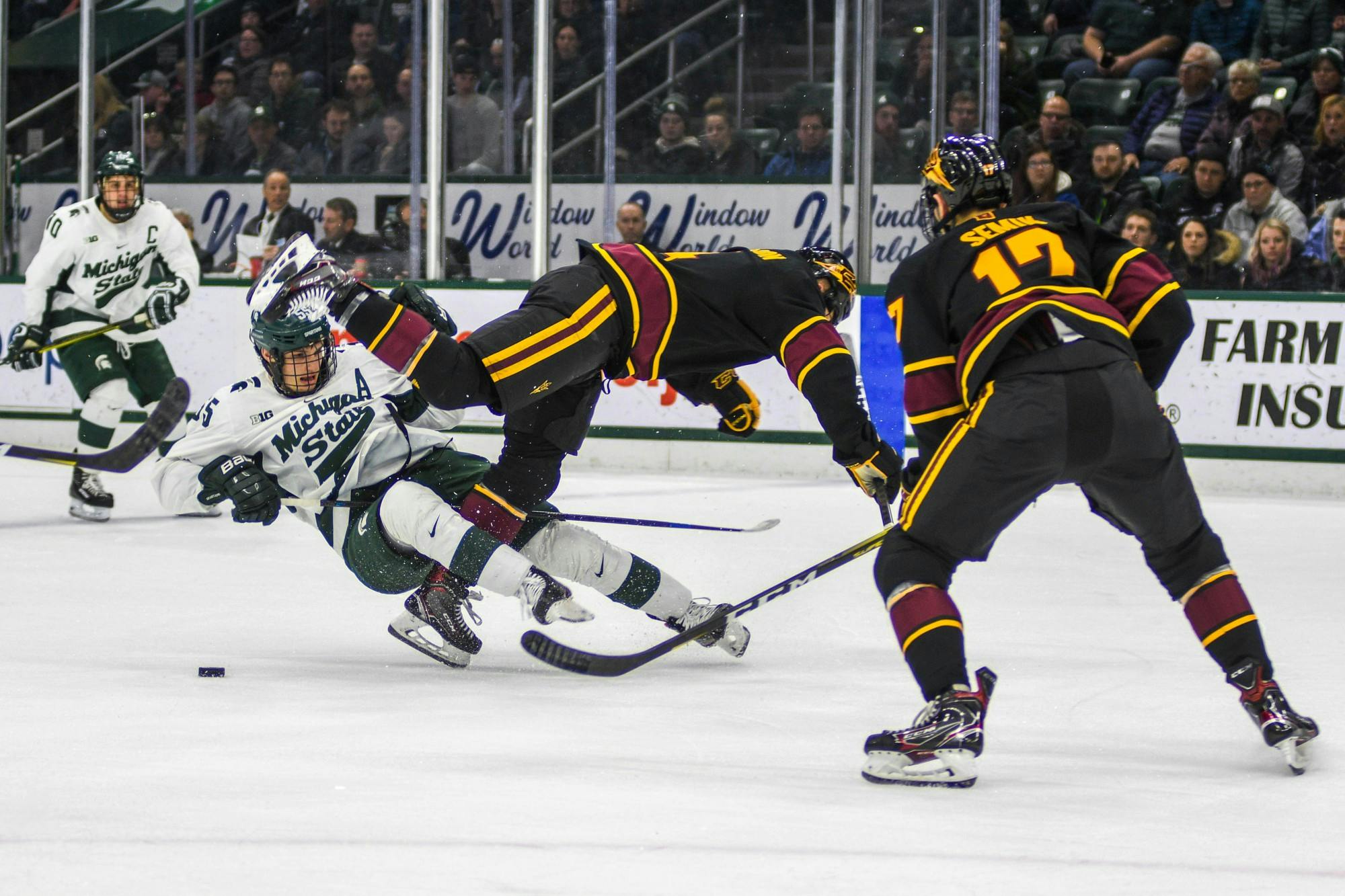Senior center Patrick Khodorenko (55) collides with an Arizona player during the game against Arizona at the Munn Ice Arena on Dec. 14, 2019. The Sun Devils defeated the Spartans, 4-3.