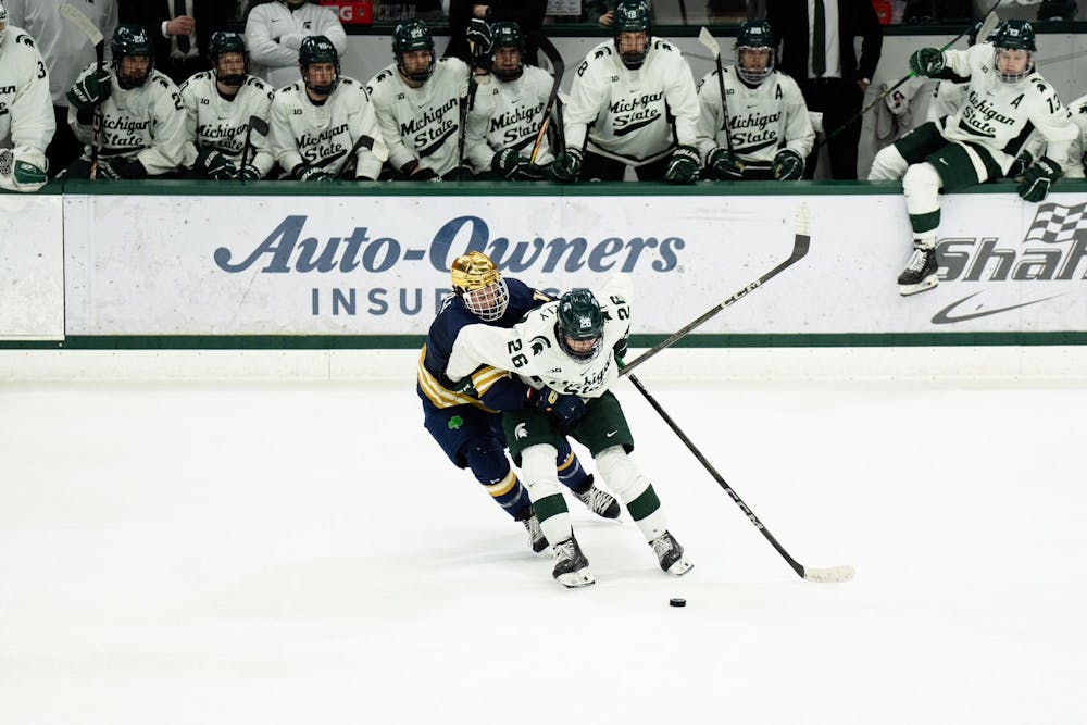 <p>Michigan State senior right wing Tanner Kelly (26) protects the puck from a Notre Dame defender at Munn Ice Arena on March 15, 2025. The Spartans took a 1-0 victory over the Fighting Irish, advancing to the Big Ten Championship.</p>