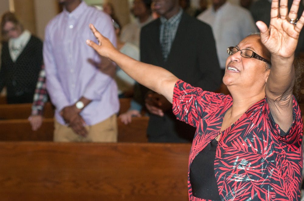 <p>Lansing resident Josie Adams worships Nov. 9, 2014, at the Epicenter Of Worship, 102 W. Grand River Ave. in Lansing. Minister Keen spoke about black spirituality in place of Pastor Sean who is currently on a retreat. Jessalyn Tamez/The State News </p>