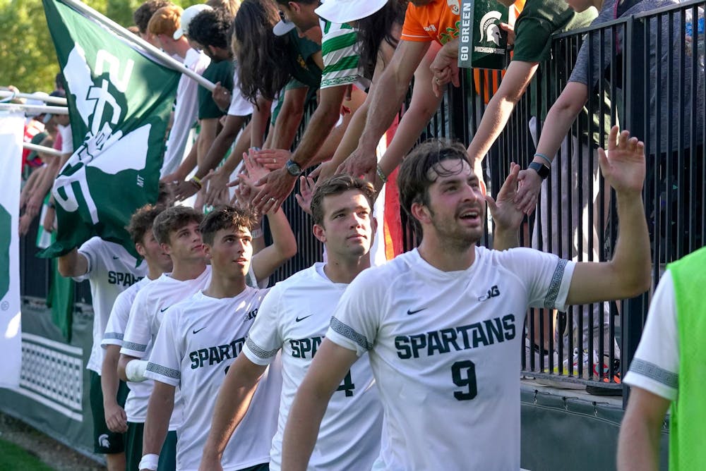<p>Senior defender Chase Inscho (4) and other Michigan State University players celebrate with fans after a game against Penn State University at DeMartin Soccer Complex on Oct. 1, 2023. The Spartans drew 0-0 with the Nittany Lions, improving to a record of five wins, zero losses, and four draws.</p>