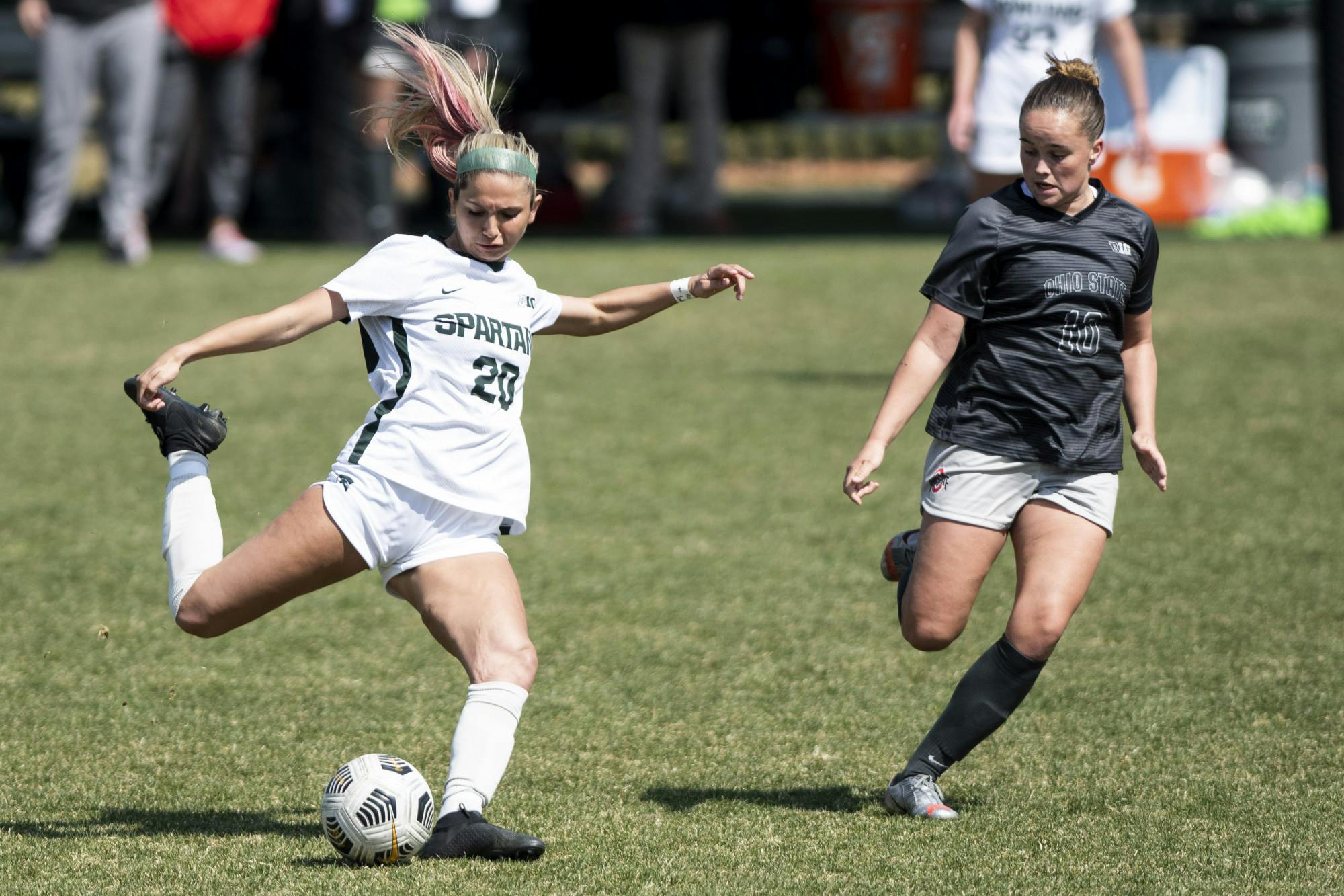 <p>Freshman defense Zivana Labovic (20) kicks the ball past an Ohio State player during the game against Ohio State on April 3, 2021, at DeMartin Stadium. The Buckeyes defeated the Spartans, 1-0.</p>