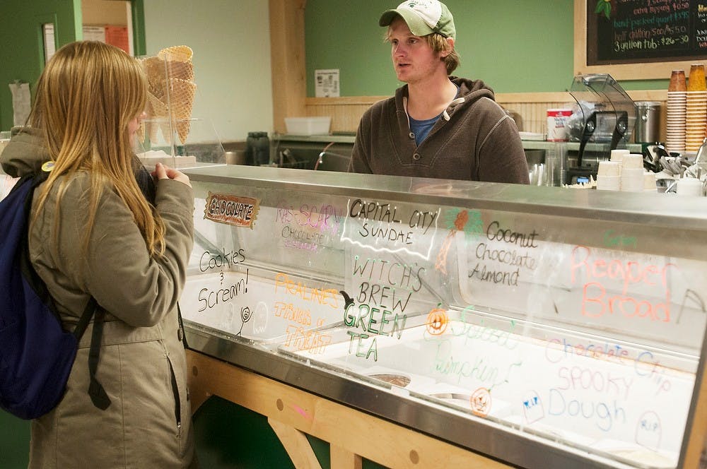 	<p>Political science senior Chris Fox takes physics freshman Abby Harbourne&#8217;s order Oct. 30, 2013, at the Dairy Store. The Dairy Store changed all their ice cream flavor names to be Halloween themed. Margaux Forster/The State News</p>
