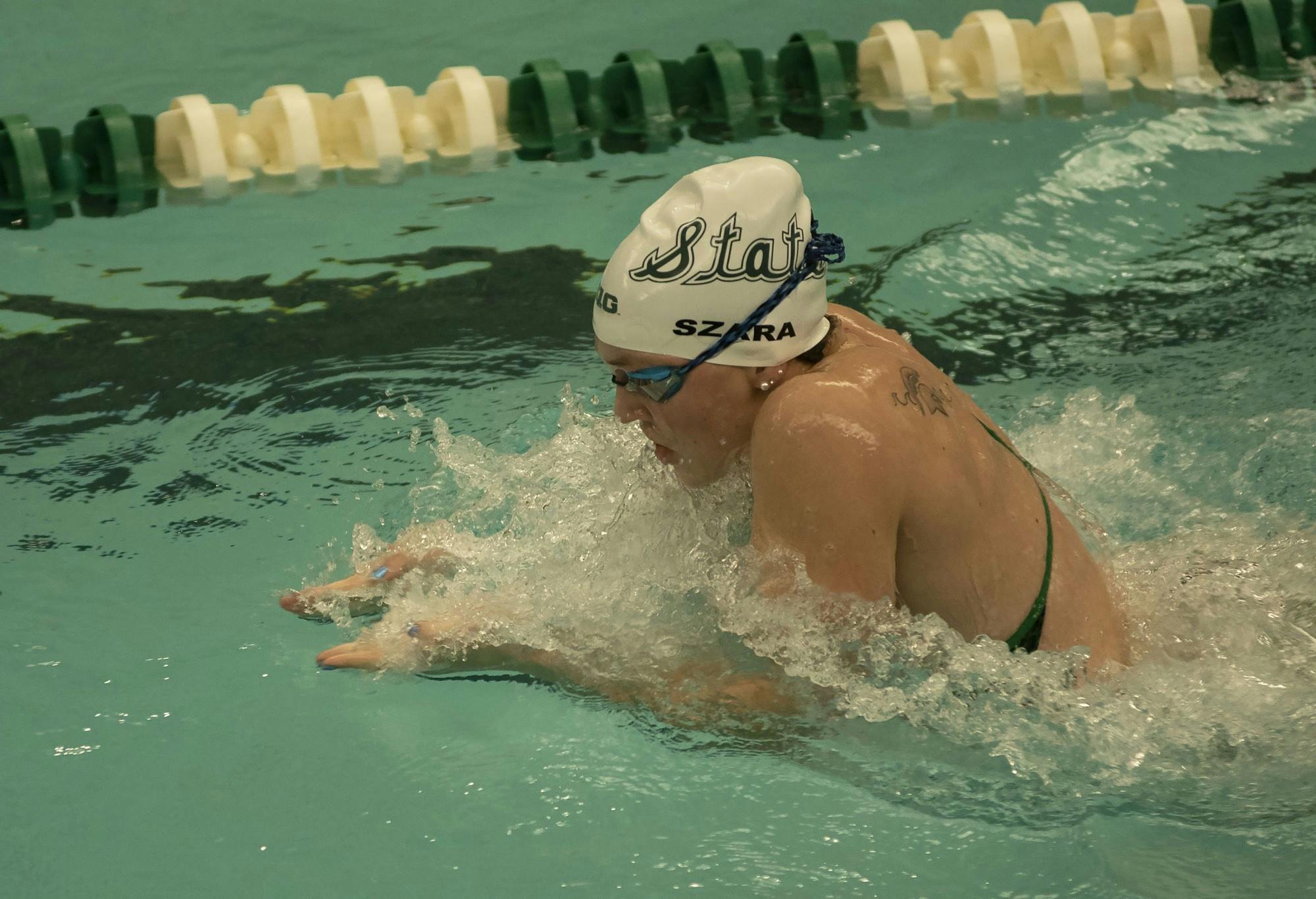 Erin Szara, junior, participates in the women's 100m breaststroke. Michigan State hosted the swim and dive meet against Oakland on January 18. 