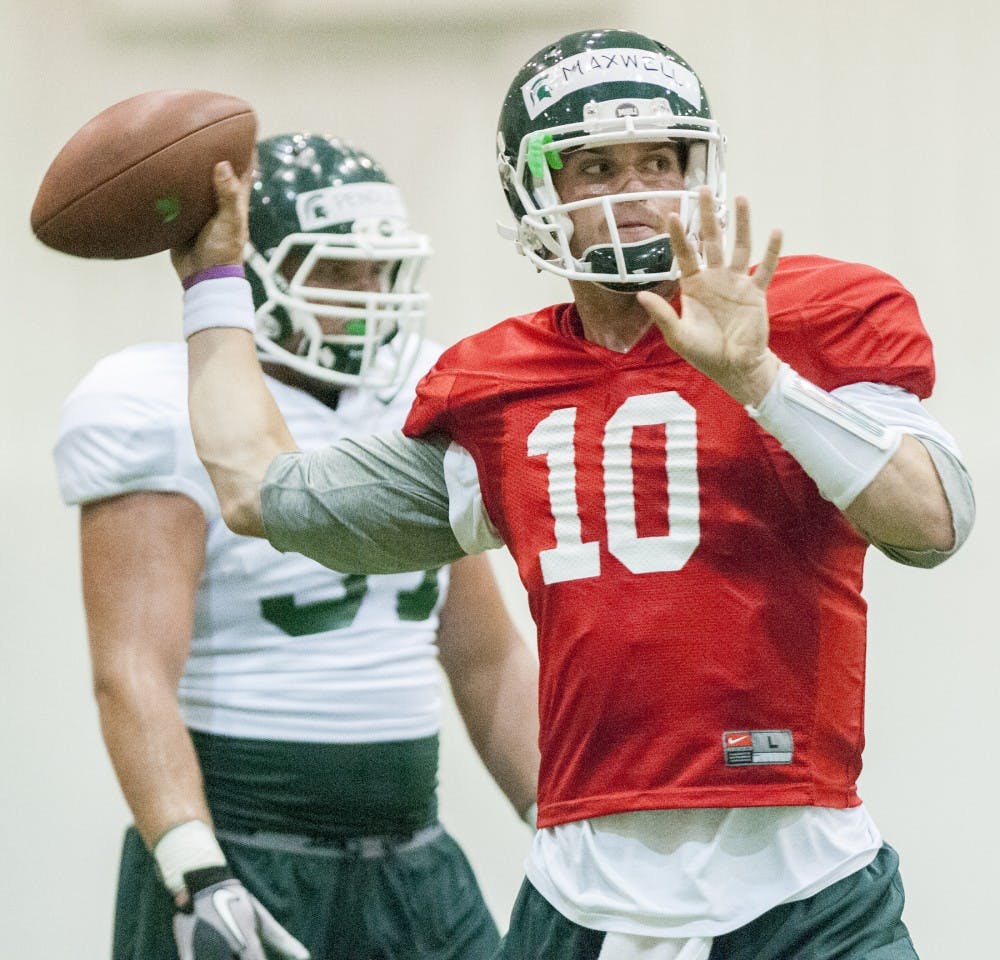 Junior quarterback Andrew Maxwell throws the ball during football practice on Monday, Aug. 13, 2012 at Duffy Daugherty Football Building. Justin Wan/The State News