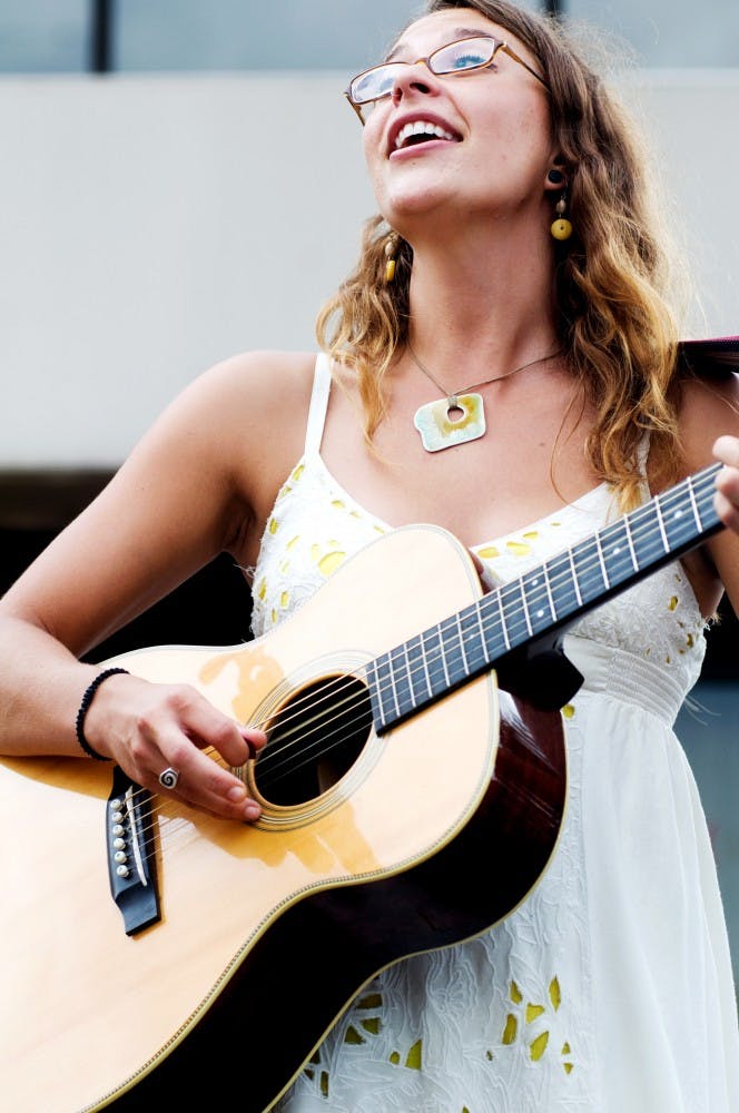 	<p>Lansing singer-songwriter Lindsay Lou performs Aug. 14 on the street at the Great Lakes Folk Festival. This annual festival takes place from Aug. 12-14 this year.</p>