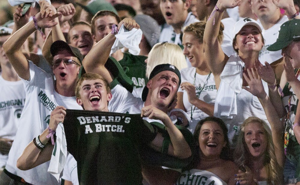 Fans cheer after noticing they are on the big screen Friday night at Spartan Stadium. MSU defeated Boise State 17-13 in the home opener. Matt Hallowell/The State News