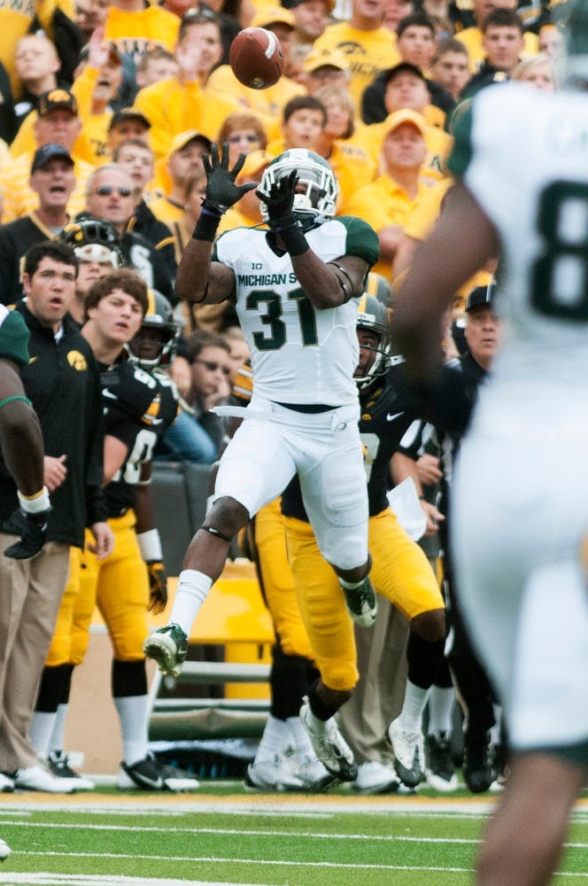 	<p>Senior cornerback Darqueze Dennard intercepts a pass in the first quarter of the game against Iowa on Oct. 5, 2013, at Kinnick Stadium in Iowa City, Iowa. The Spartans defeated the Hawkeyes 26-14. Khoa Nguyen/The State News</p>