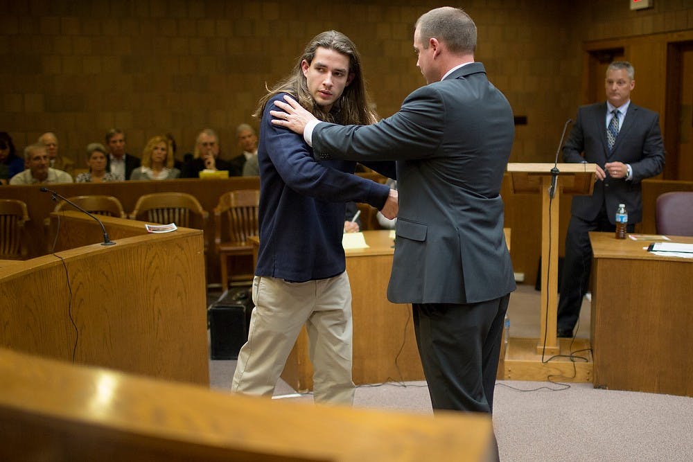 	<p><span class="caps">MSU</span> alumnus Tyler Aho, left, demonstrates the grappling and actions of defendant Connor McCowan with detective in charge of the investigation, Meridian Township police Sgt. Andrew McCready  during the preliminary exam for the teen accused of stabbing <span class="caps">MSU</span> student Andrew Singler to death, April 18, 2013, at Ingham County District Judge Donald Allen&#8217;s courtroom in Mason, Mich. Aho was Singler&#8217;s roommate and witnessed the altercation. Natalie Kolb/The State News</p>