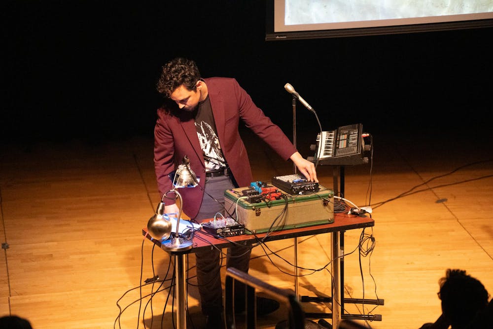 A member of Worm Moon sets up to perform soundscapes to accompany Dennis Hinrichsens poetry in East Lansing, Mich., on Feb. 25, 2026.
