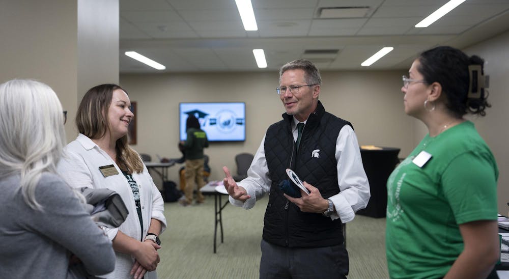 Heather Shea (affiliate faculty for Student Affairs PRXIS and professional development), Sarah Ward (Assistant Director for First-Generation Student Success), MSU President Guskiewicz, and Marlene Villa (Coordinator for First-Generation Student Success and Chair of the First-Generation Week Planning Committee) (left-right) discussed first-generation student opportunities on campus at the Union on Nov. 4, 2024.